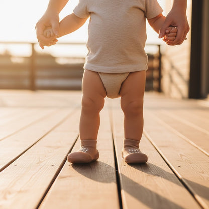 Little feet standing steady in sock sneakers