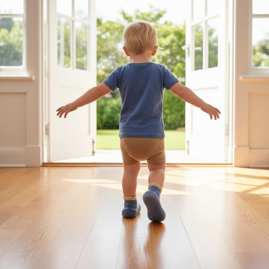 Toddler walking steadily on floorboards