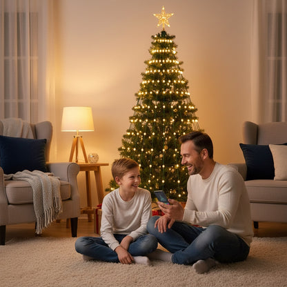 Dad and son choosing a colour in the app, tree lit warm white