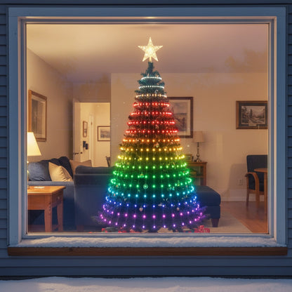 The lit tree seen through the front window at night